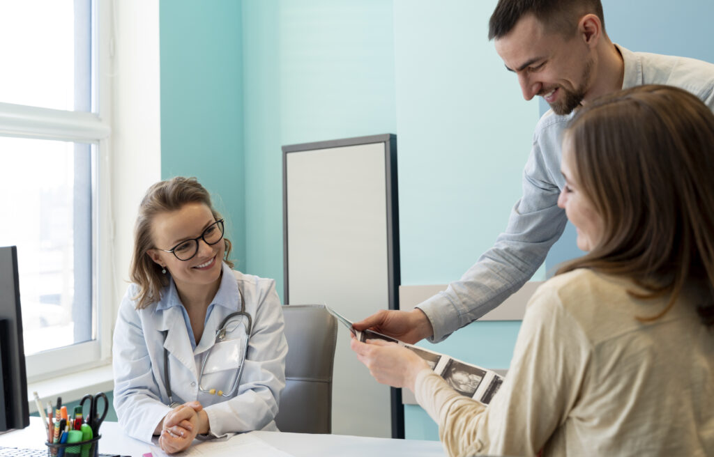 Gynecologist evaluating pregnancy with patient