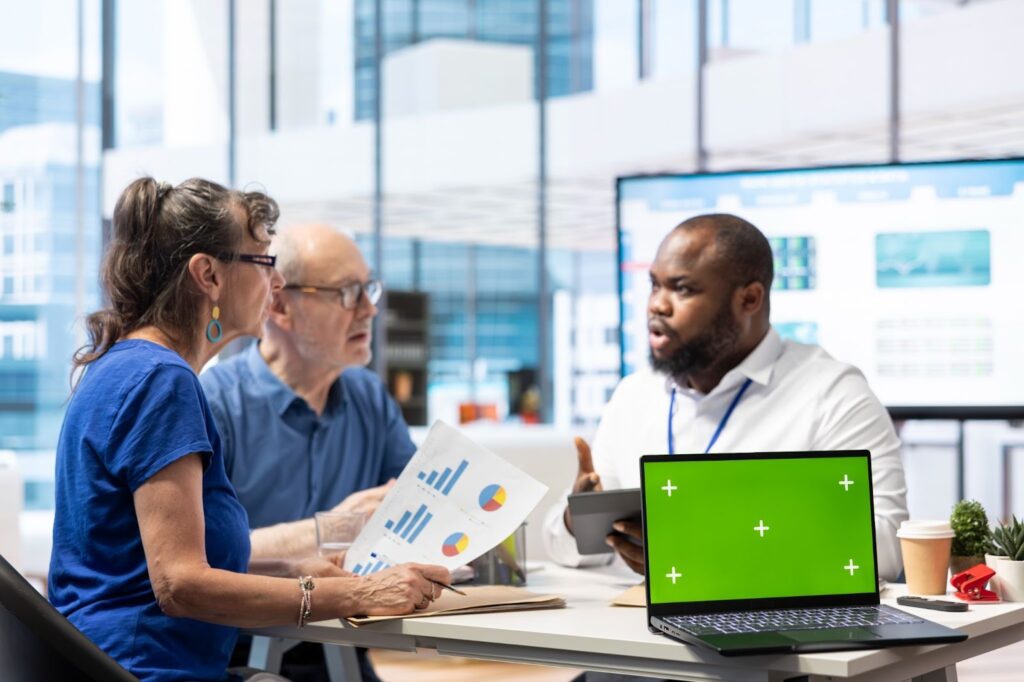 banker offering pension plan options to seniors next to an isolated screen