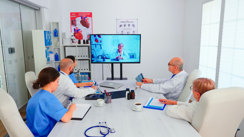 Group of doctors discussing with expert medic during video conference