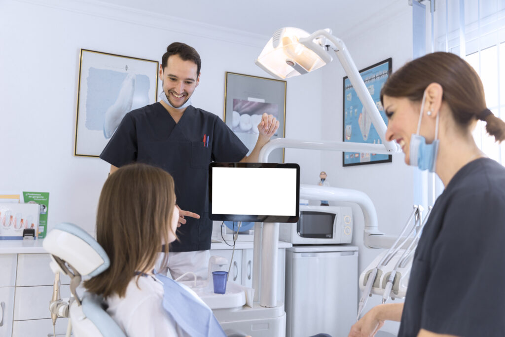 smiling patient and dentist talking in a dental clinic